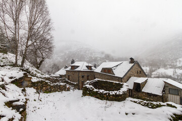 an old stone barn in a beautiful snowy mountain village
