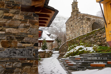 A snowy mountain town with a sign that says: El Aguzo