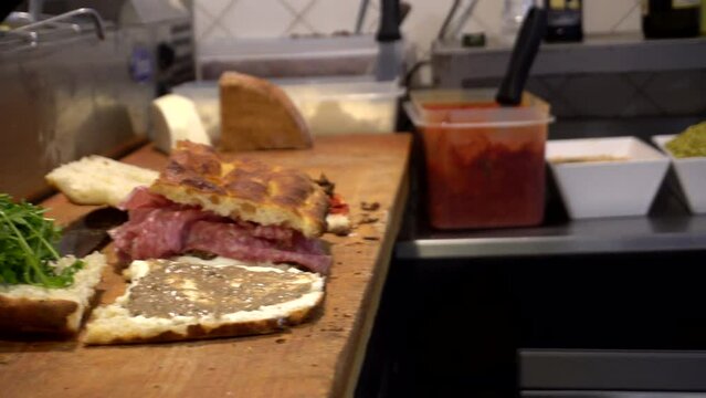 Freshly cook Italian sandwich in Florence bread salami slice meat vegetable and sauce