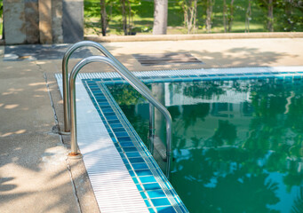 Obraz na płótnie Canvas Hotel swimming pool with sunny reflection