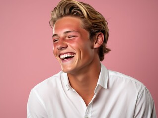 A man with blonde hair is smiling and laughing