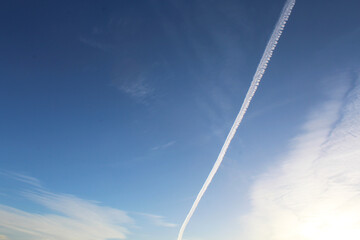 white plane trail in the sky