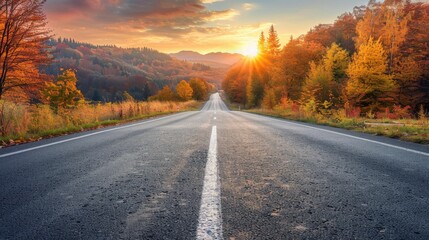 Black asphalt road landscape at sunset in beautiful colorful nature. Highway scenery among mountains in autumn season. Nature landscape on beautiful road in colorful fall. Autumn landscape in Germany