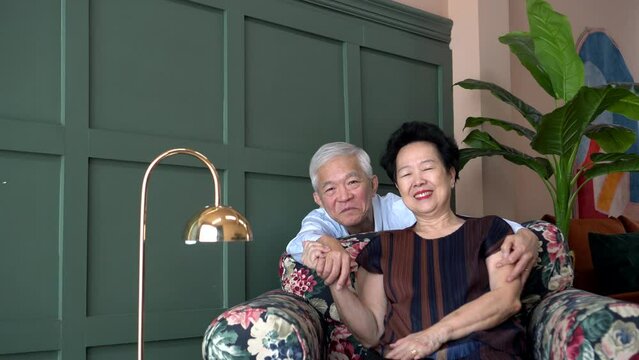 Wealthy rich lovely Asian old senior elderly couple in luxury home hold hand smile