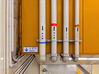 White pipes on a yellow background in the subway