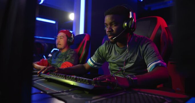 Professional esports gamers celebrating a win at a gaming tournament