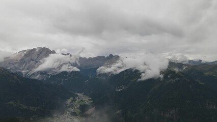 Mountain peaks of Italian Dolomites hiding behind the fog