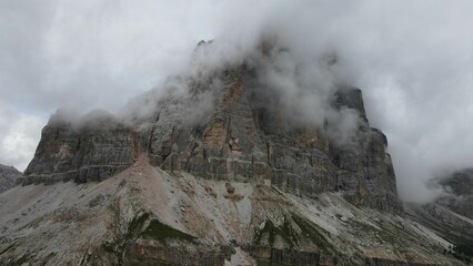 Fototapeta premium Aerial of the mountain peaks of Italian Dolomites hiding behind the fog