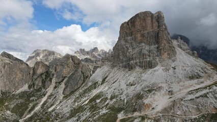 Aerial of the mountain peaks of Italian Dolomites hiding behind the fog