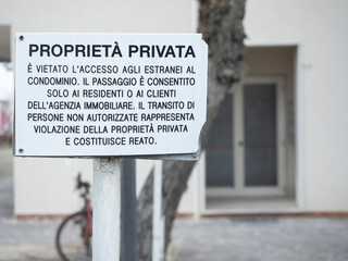 Un cartello che avverte la proprietà privata e il divieto di sconfinare davanti a una casa. Un segnale di avvertimento.