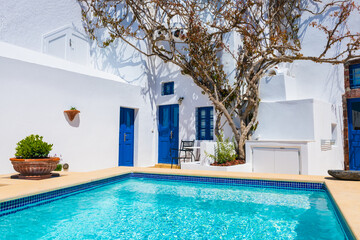 White architecture in Santorini island, Greece. Beautiful terrace with swimming pool