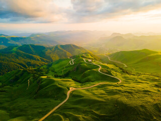 View of the green mountains and hills at sunset. Gumbashi Pass in North Caucasus, Russia.