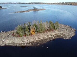 Aerial view of the small island with trees in autumn