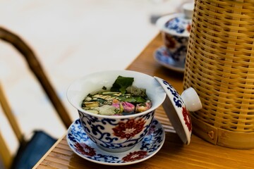 Closeup of a typical Chinese tea cup with an open lid