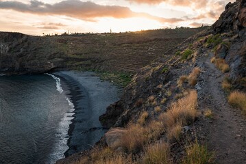 Aerial shot of a seashore surrounded by hills