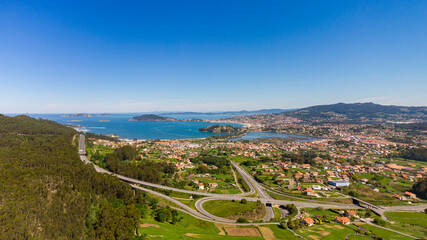Aerial panorama of the surroundings of Baiona (Galcia). The highway in the foreground, Baoina beach, the mouth of the Mi&ntilde;or River, Monte Lourido and the C&iacute;es Islands in the background