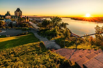 Beautiful view of the Chateau Frontenac surrounded by greenery in Quebec, Canada at sunrise