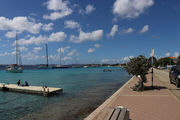 Kralendijk oceanfront road with view at mooring points and sailing yachts, Bonaire, Caribbean Netherlands - obrazy, fototapety, plakaty