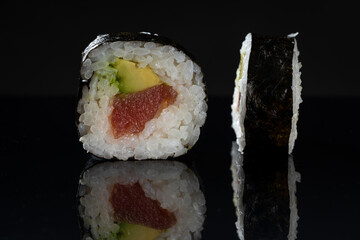 Sushi rolls with tuna and avocado. Sushi with reflection. Traditional japanese food - 774097566