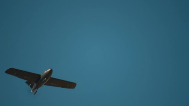 Military Drone aircraft scout Flight in blue Sky Close-up slow motion. Modern Military Copter Technology Concept. 4k UHD 3840x2160.