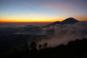 Beautiful sunrise over the mountain covered with clouds