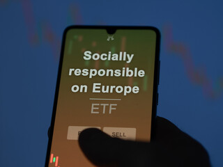 An investor analyzing the socially responsible on europe etf fund on a screen. A phone shows the prices of Socially responsible on Europe