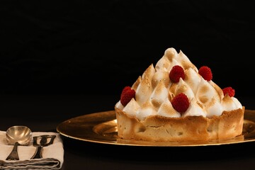 Closeup of a cake with raspberry and meringue