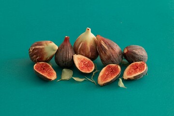 Closeup shot of fig fruits in a cut on reen background