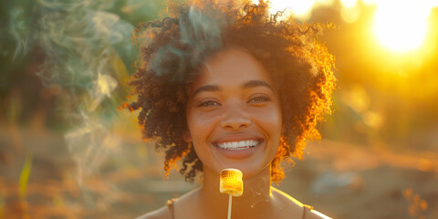 Portrait of an African American woman roasting marshmallows on a stick, laughs with delight as she watches them turn golden brown, the sweet scent filling the air with anticipation