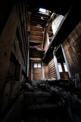 Vertical shot of an interior of an abandoned wooden house