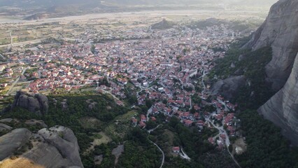 Aerial view of Meteora rock formations surrounded by buildings