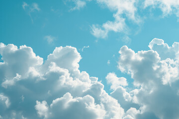 A blue sky with numerous white fluffy clouds scattered across it - obrazy, fototapety, plakaty