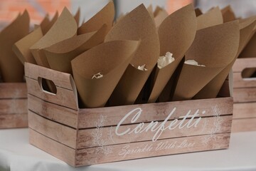 Flowers petals use as confetti stored inside small brown paper cone to celebrate wedding events.