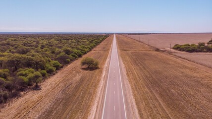 Fototapeta na wymiar Aerial view of a highway road in the middle of the field