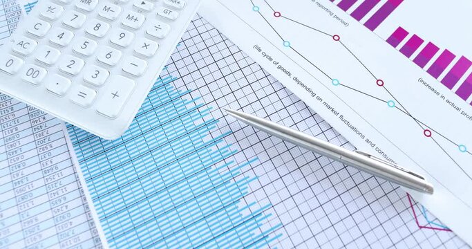Business charts calculator and financial documents lie on table. Marketing statistics and analytics concept