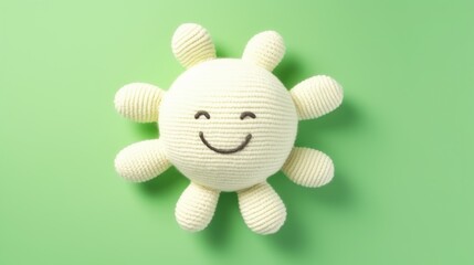 Knitted, cute sun with a smile on a green background, top view, with space for text. Greeting card, hobbies, knitting, children's toys.