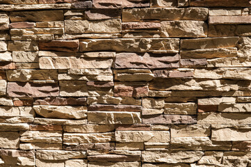 exterior wall of non-uniform stones well placed in relief, of a brown-colored house
