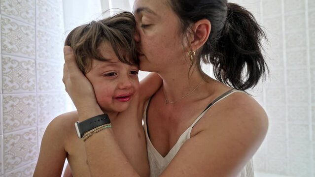 Little Boy Consoled By Mother As He Cries Profusely After Getting Hurt