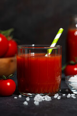 glass of fresh tomato juice with sea salt, vertical closeup