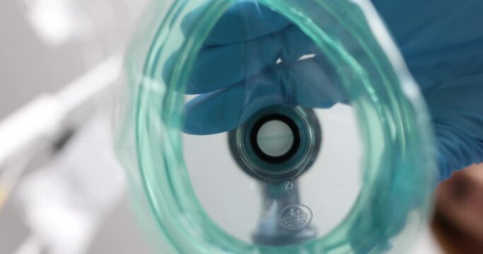 Doctor in medical gloves putting oxygen mask on patient. Idea of infection narcosis and respiratory diseases concept