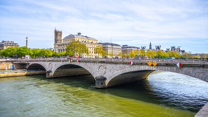 Arched Pont au Change spans the Seine River against a backdrop of Parisian architecture on a clear day. Paris, France - 774143738