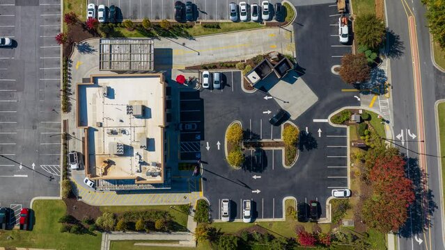 Fast Food Restaurant Cars in Drive Thru. Top Down Aerial Time Lapse View in Day.