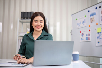 Beautiful business woman with determination Working on laptop in modern office