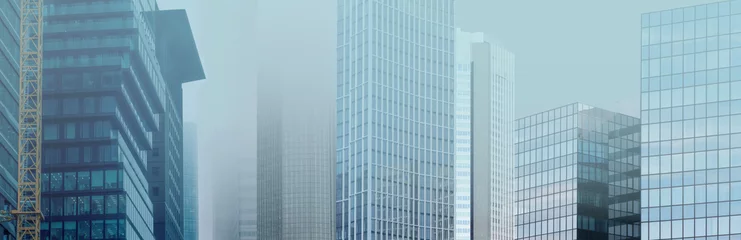 Fototapeten skyscrapers buildings disappear into the mist, creating mysterious and atmospheric urban landscape with blurred outlines and obscured details, Weather Conditions, German Engineering © kittyfly