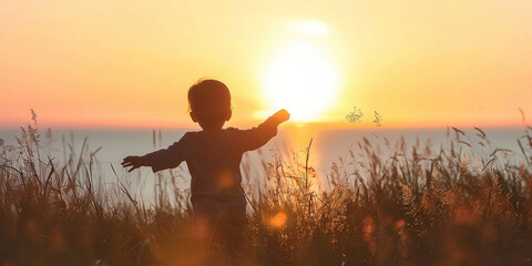 Child Standing in Field at Sunset with Sun Setting in Distance, Tranquil and Serene Nature Scene