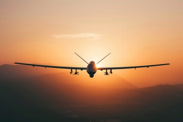Glider aircraft flying against sunset