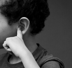 deaf boy suffering from deafness and hearing loss on grey background with people stock image stock...