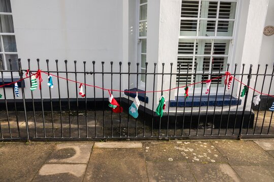 knitted Christmas Stocking Bunting hanging from railings