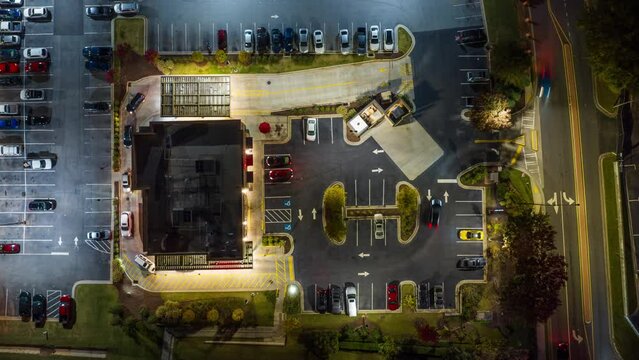 Fast Food Restaurant Cars in Drive Thru. Top Down Time Lapse View at Night.