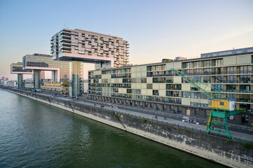 Promenade at the Rhine Harbor in Cologne, Germany: Modern apartment and office buildings line the formal industrial harbor